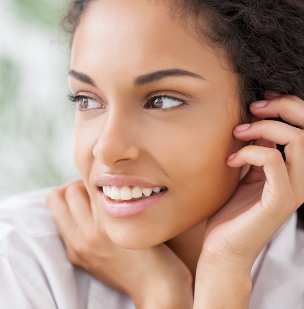 Woman tucking hair behind ear