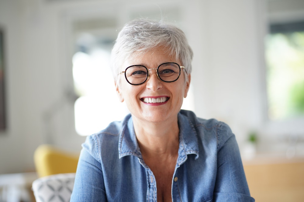 Smiling older woman with dental implants