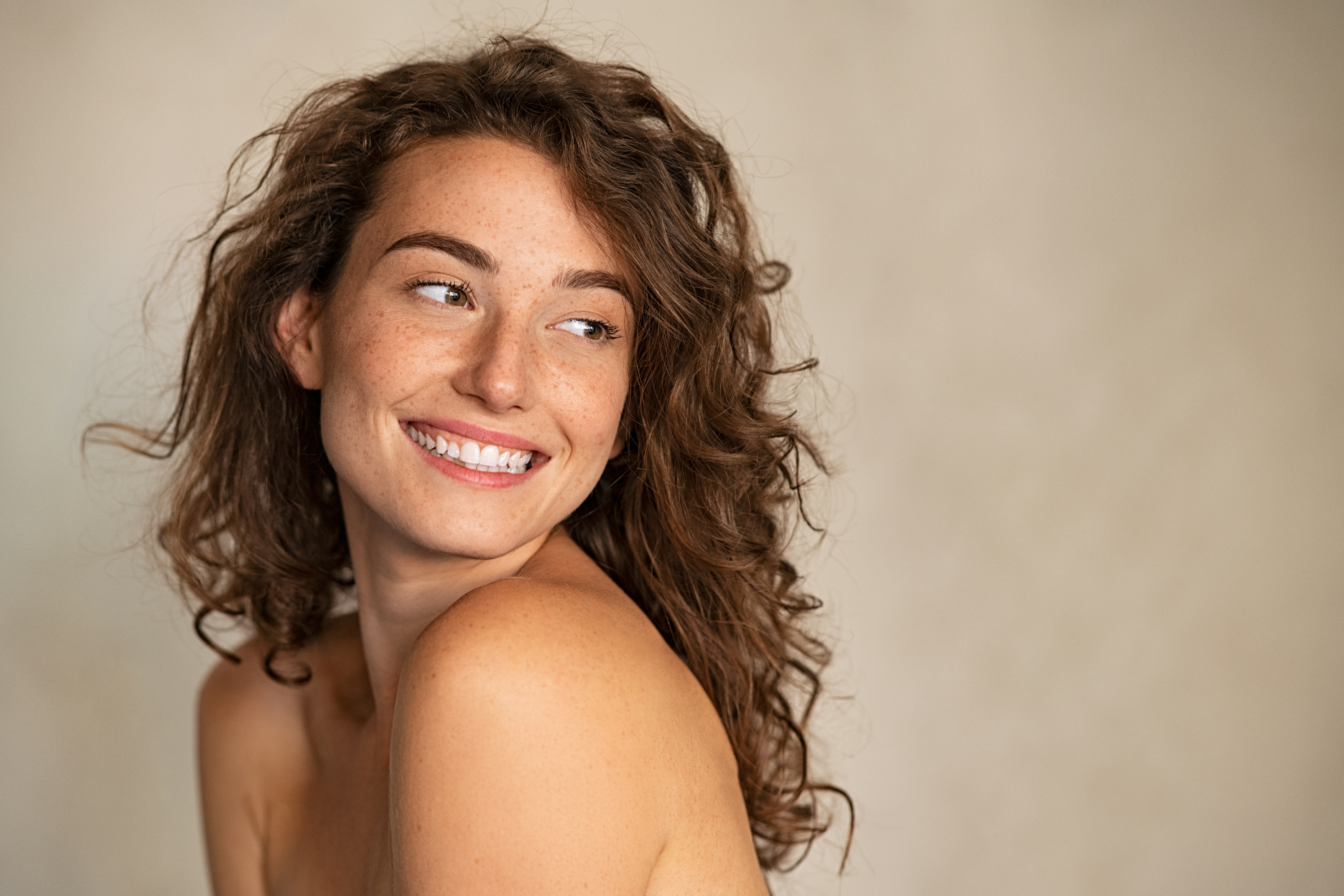 Woman looking over her shoulder, smiling
