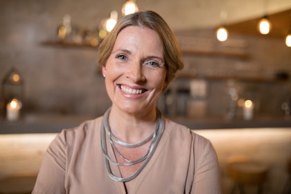 Smiling woman wearing silver necklace