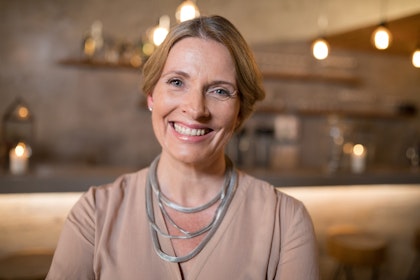 Smiling woman wearing silver necklace