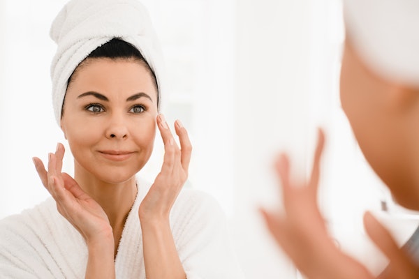 Mature woman doing skincare
