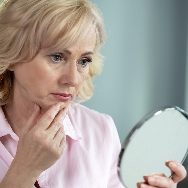 Woman looking in mirror