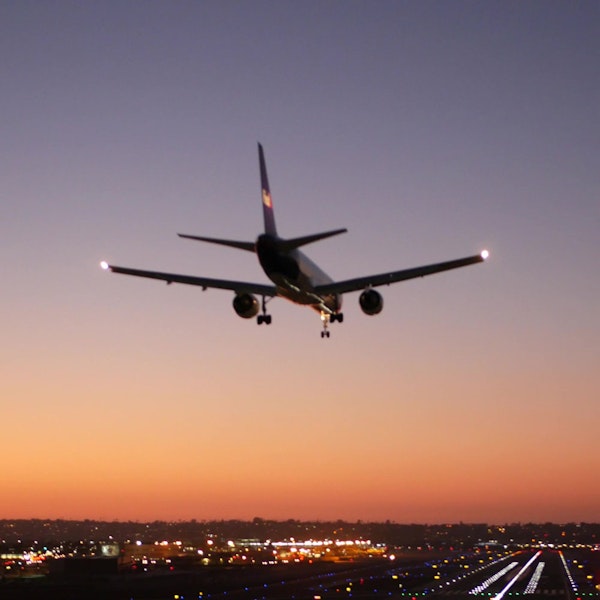 Airplane flying at dusk