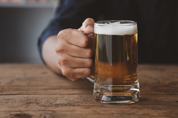 Person holding a glass of alcohol