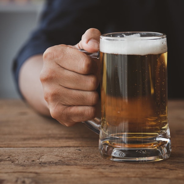 Person holding a glass of alcohol
