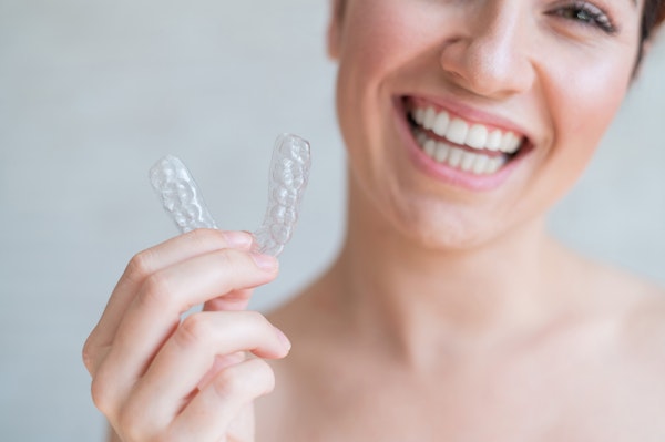 Woman holding ClearCorrect aligners up close