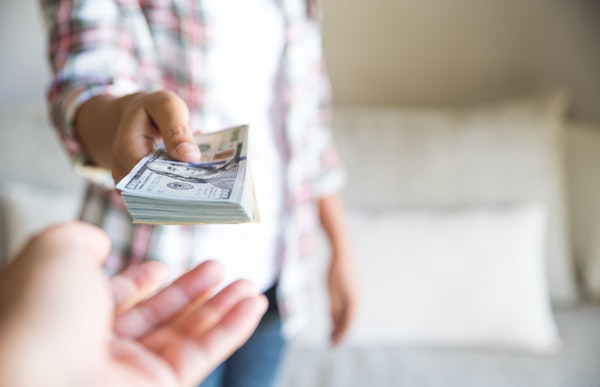 Co-parent giving money to other co-parent