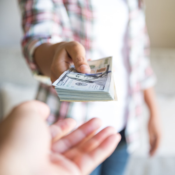 Co-parent giving money to other co-parent