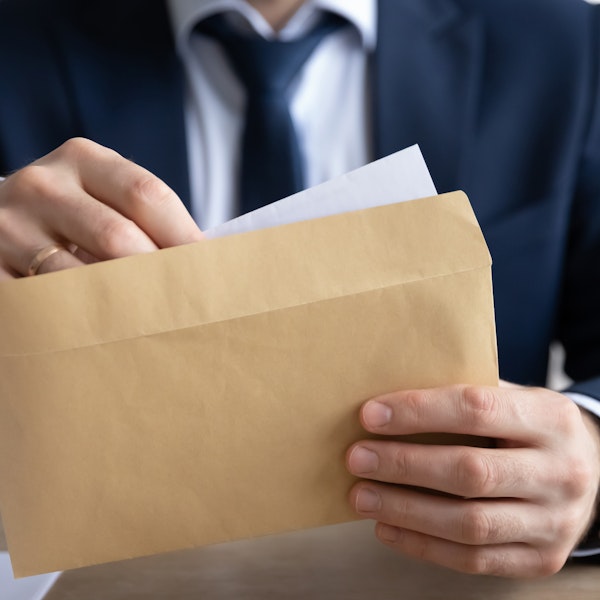 Man taking a check out of an envelope