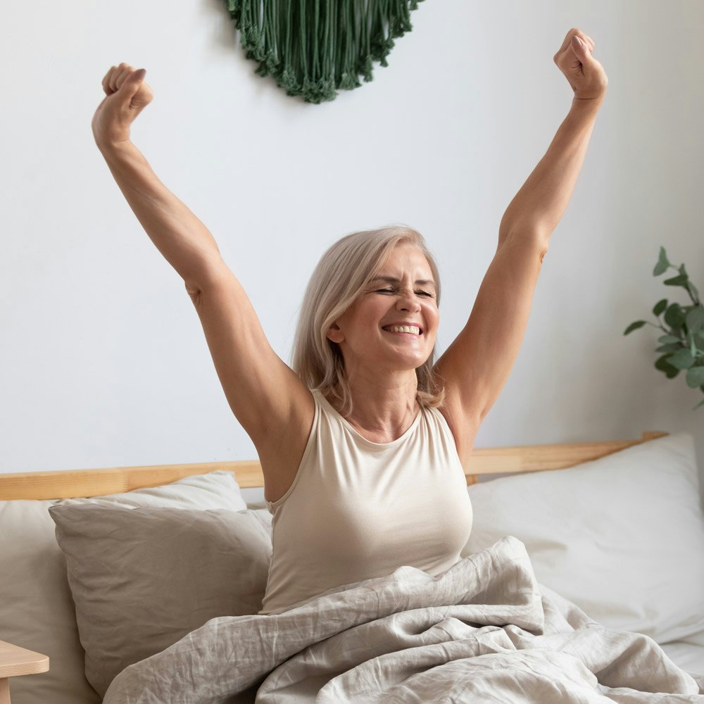 Woman stretching in bed