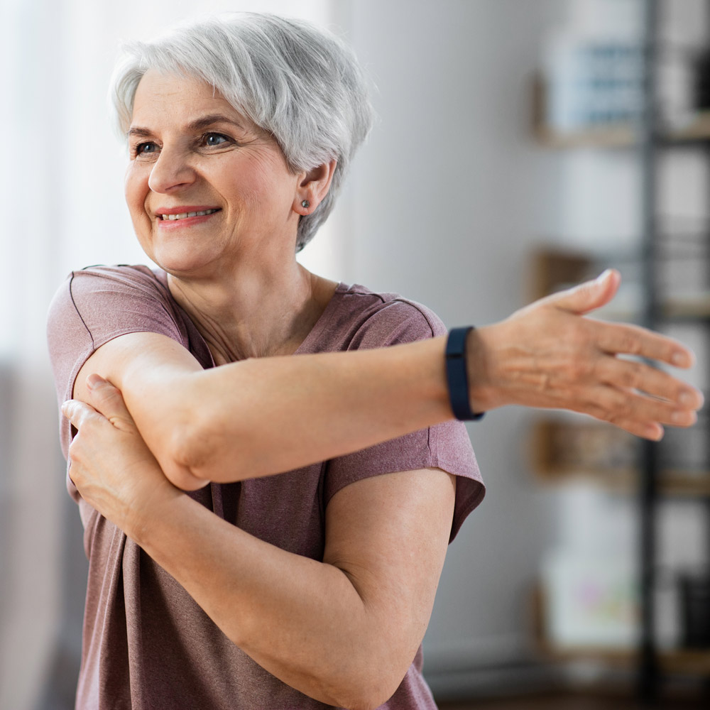 Mature woman smiling while exercising
