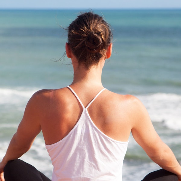 Woman relaxing outside with upper body lift back view