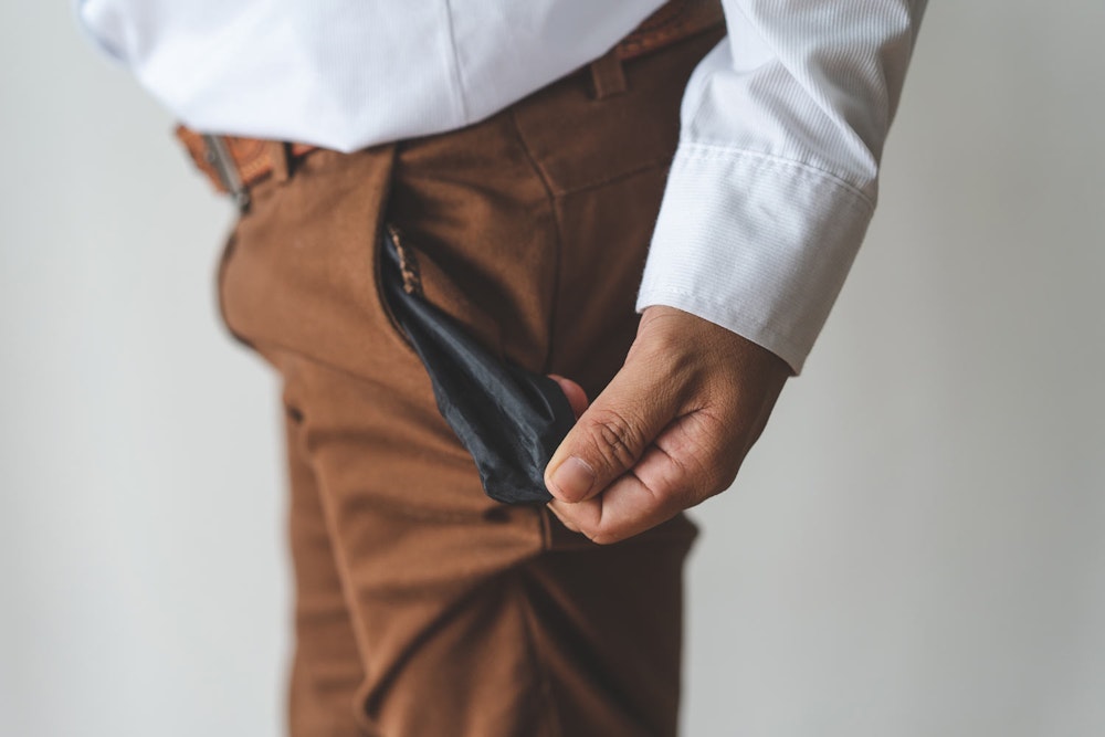 Man opening empty pockets