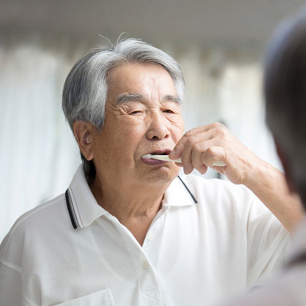 Mature man brushing teeth