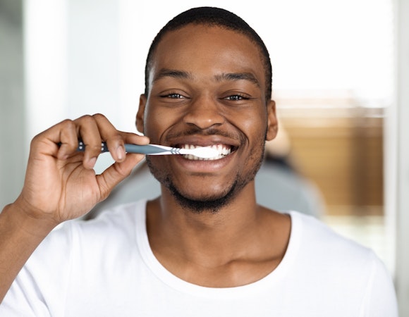 man brushing teeth