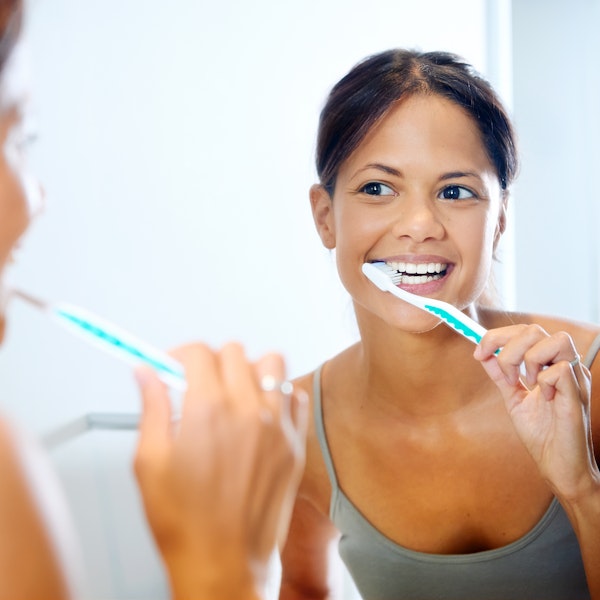 Young girl brushing her teeth