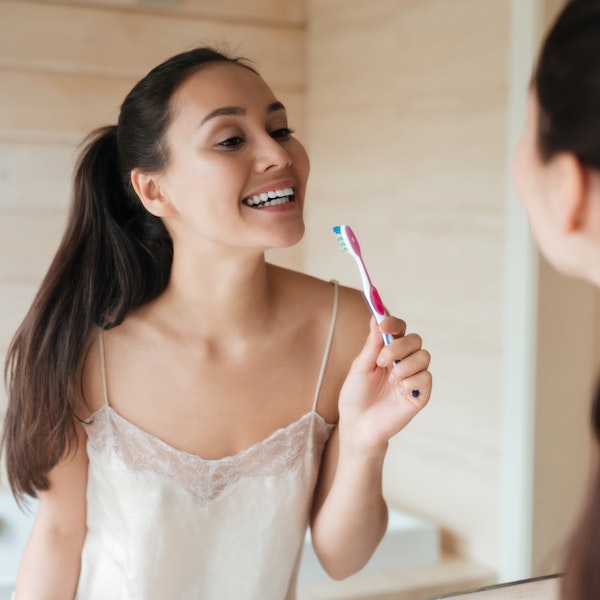 Woman brushing her teeth