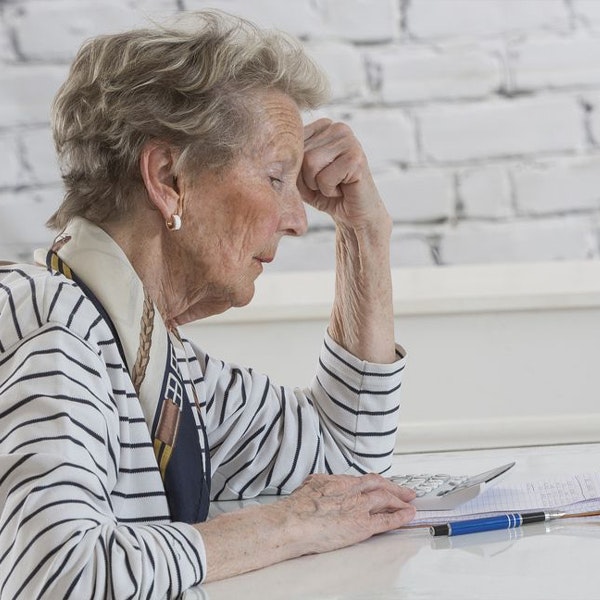 Sad lady looking at bills