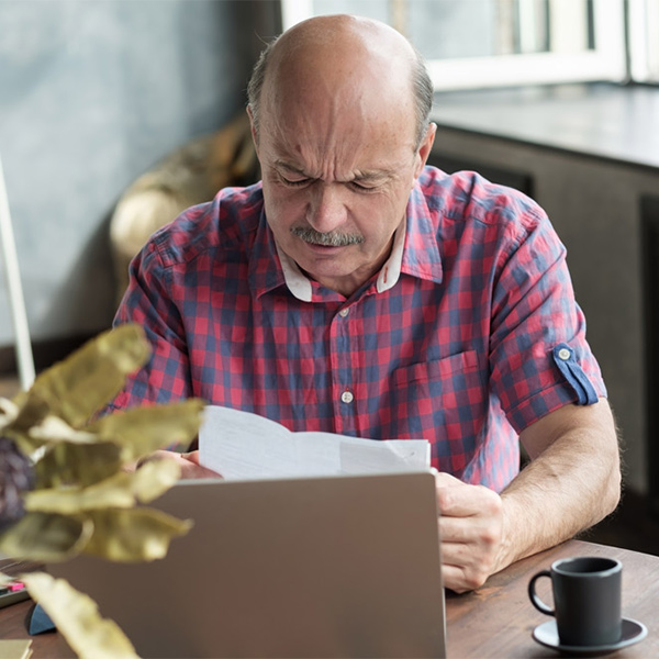 Sad man looking at bills