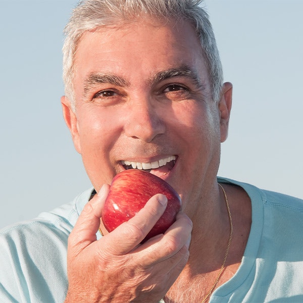 Senior man biting into apple