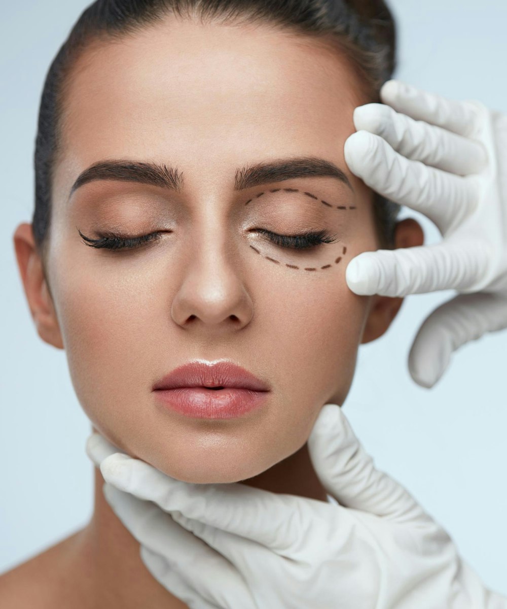 Doctor examining area around woman's eye