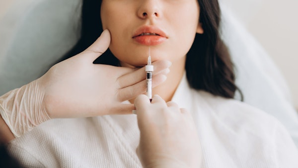 Woman receiving BOTOX in forehead
