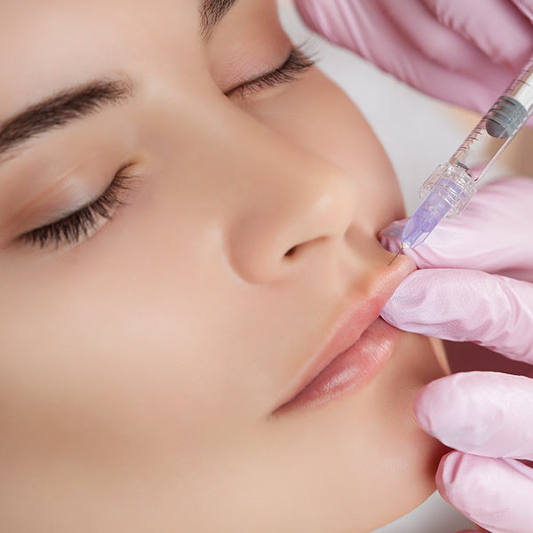 Close up of woman receiving BOTOX in lips