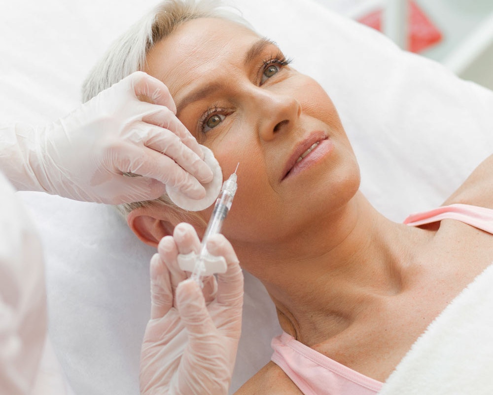 Mature woman getting BOTOX in face