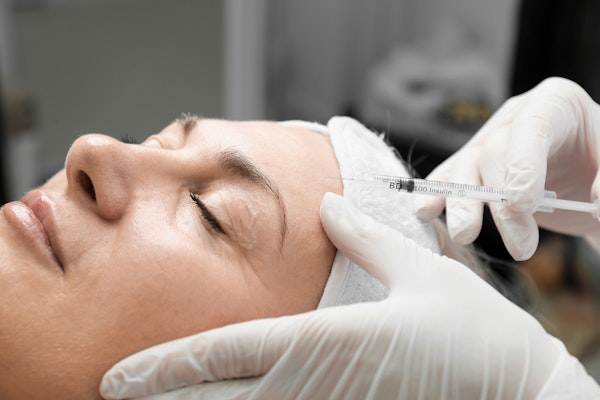 Mature woman receiving BOTOX in forehead