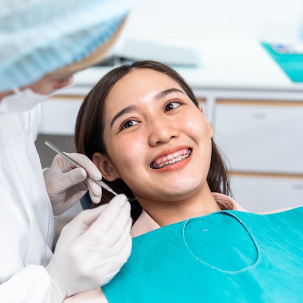 Smiling dental patient with braces