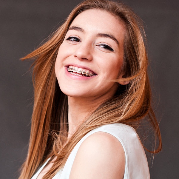 Smiling young woman with braces
