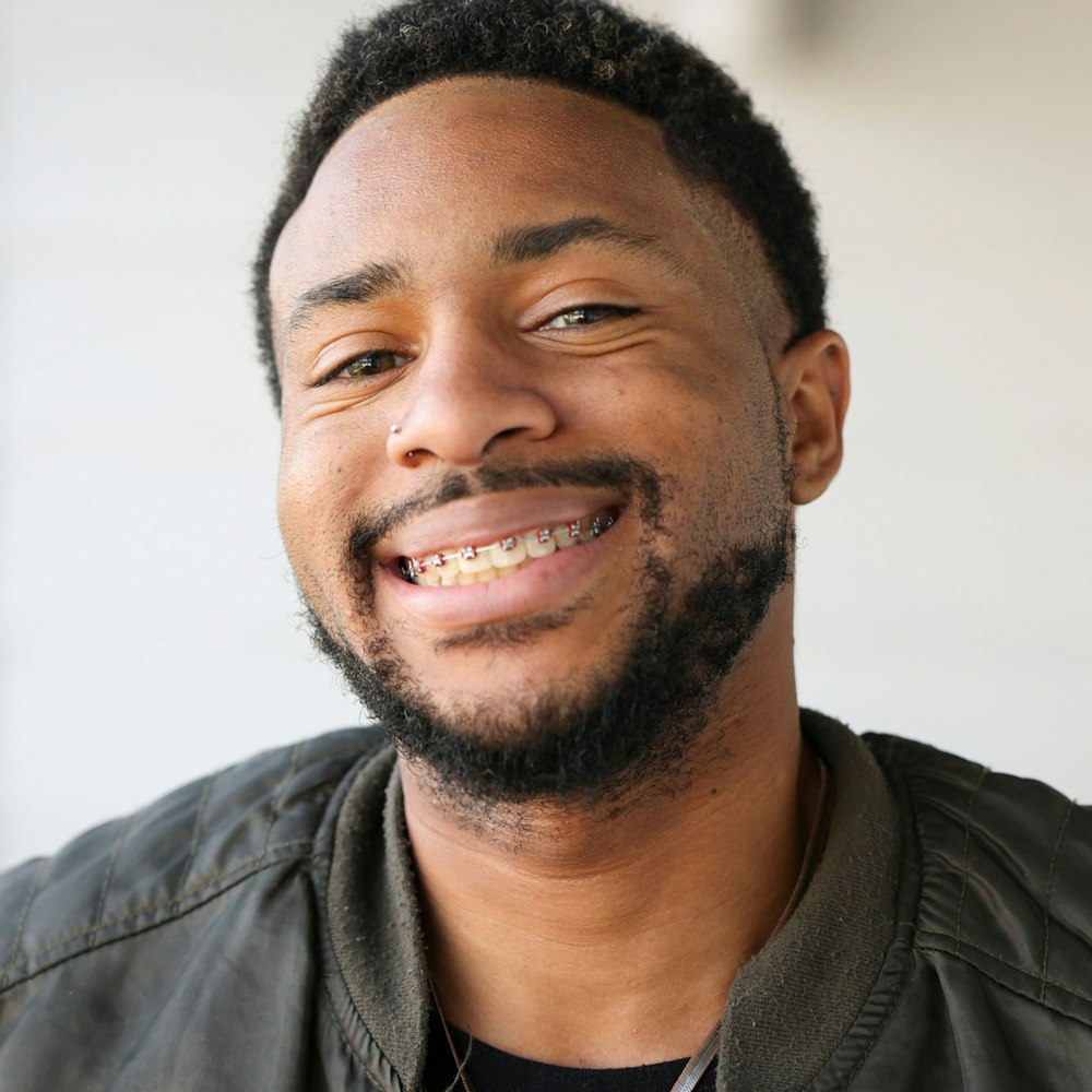 Smiling man wearing braces