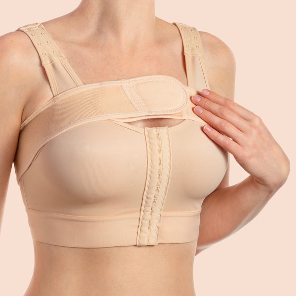 Breast compression garment