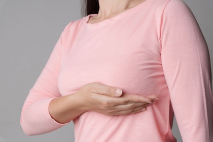 woman holding breast