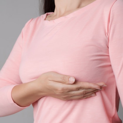 woman holding breast