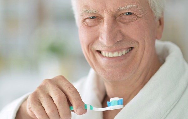 Smiling Man Brushing Teeth