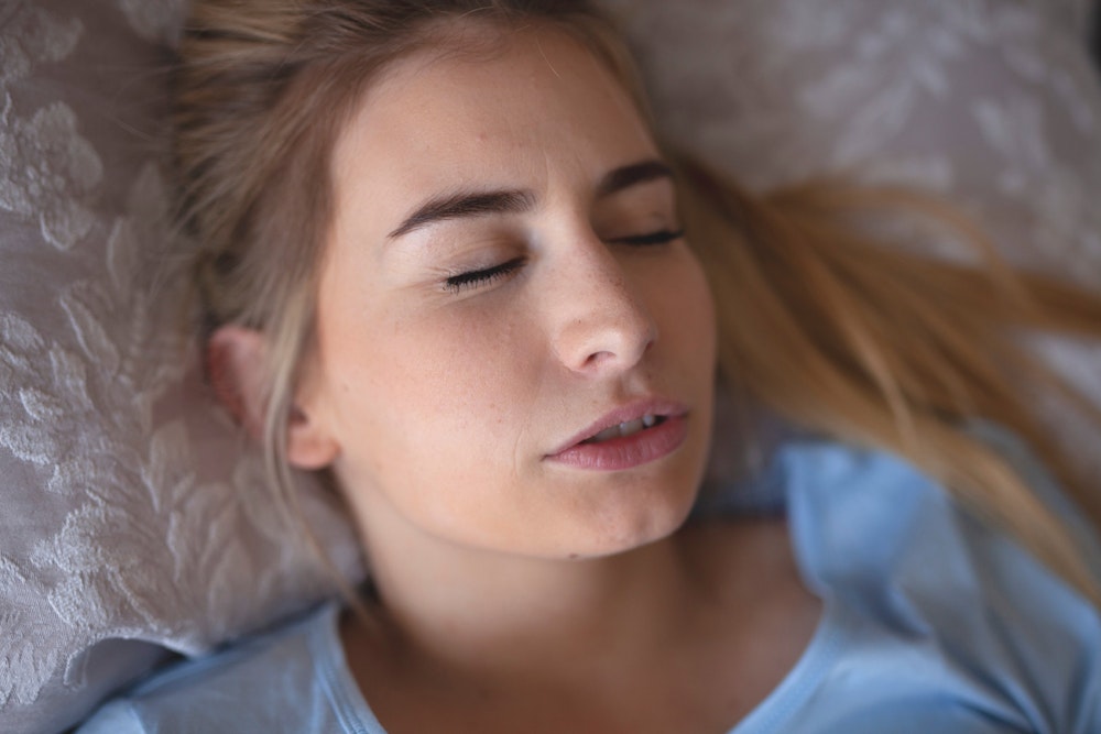 Woman grinding teeth in bed
