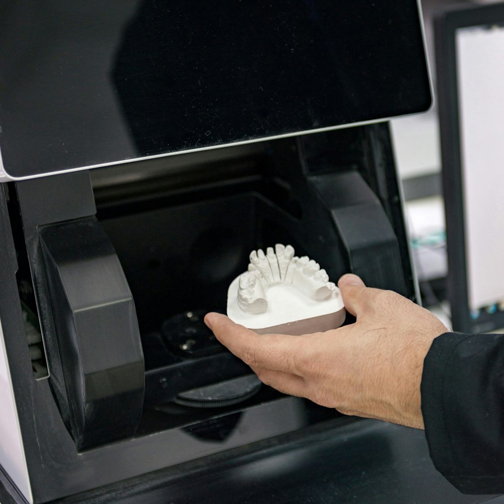 Impression being taken out of a machine