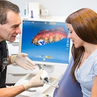 Dentist and patient discussing CEREC system
