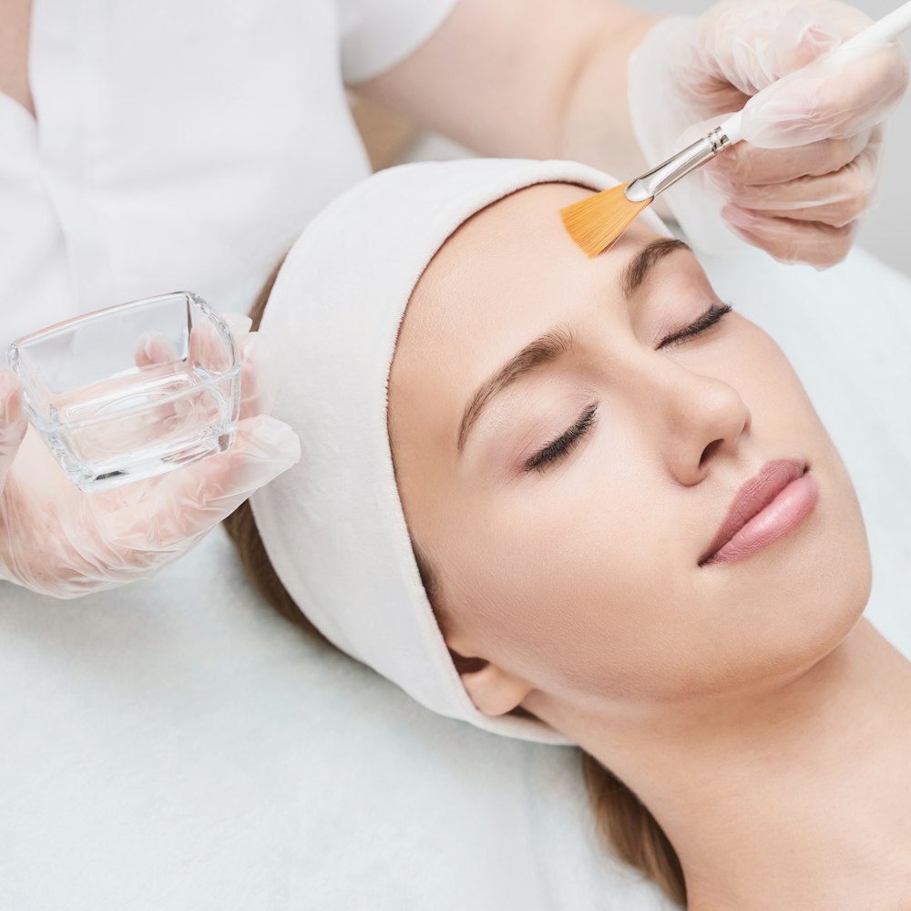 Woman receiving chemical peel treatment