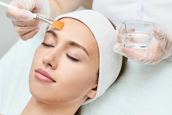 Woman receiving chemical peel