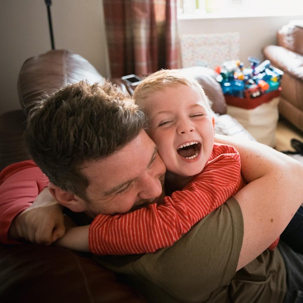 Father hugging son and laughing
