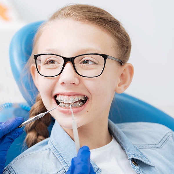 Child with braces visiting dentist