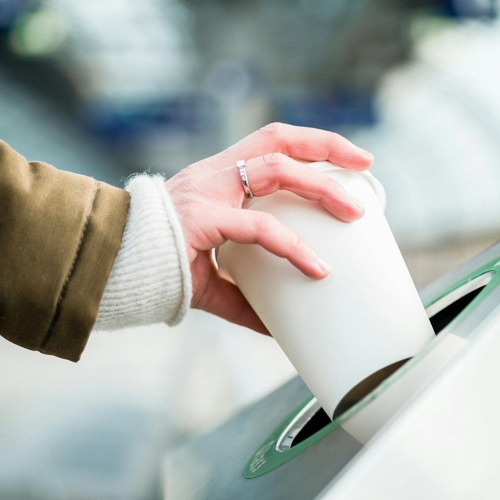 Woman throwing away coffee cup