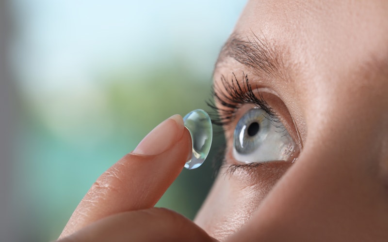 woman putting on a contact lens
