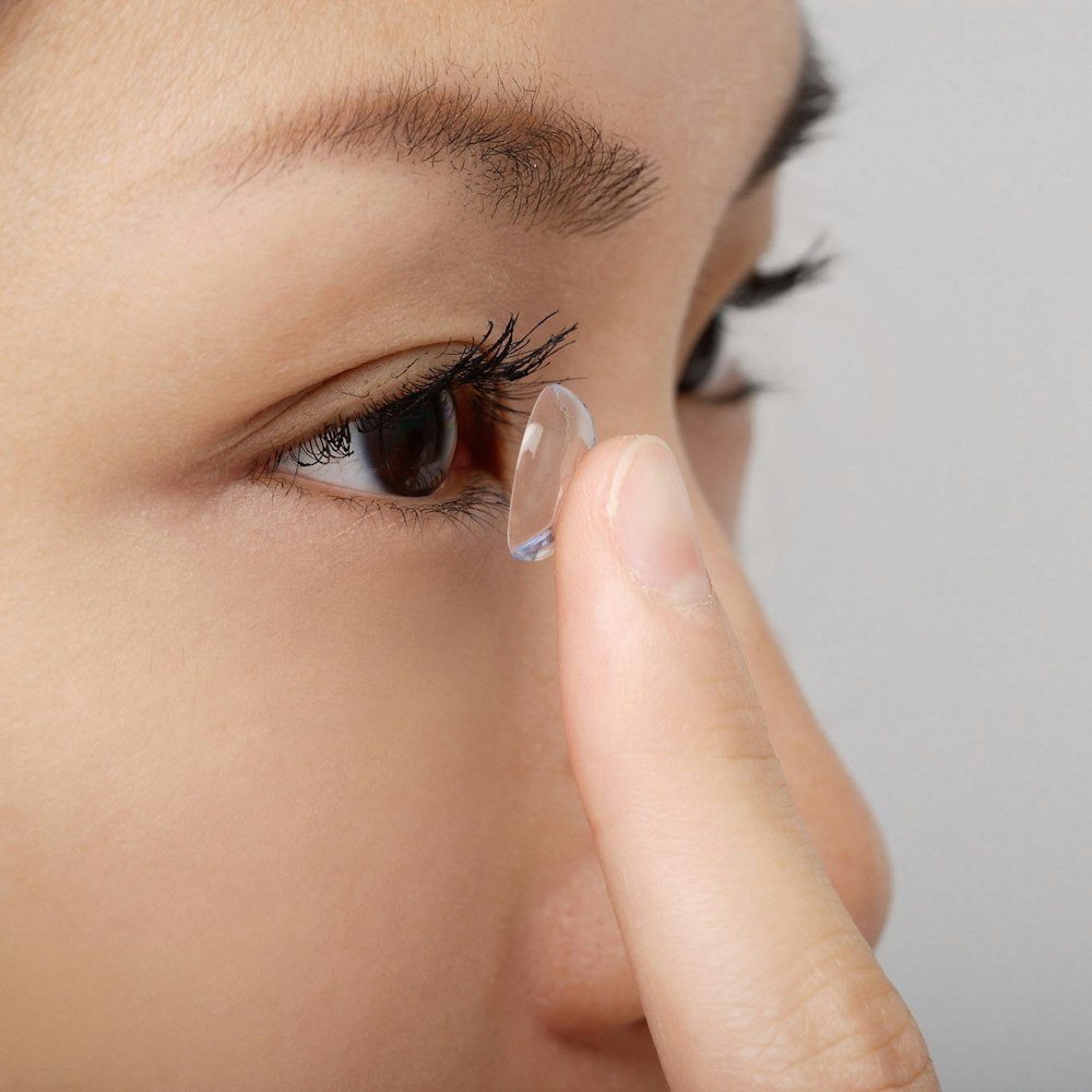Woman putting on a contact lens