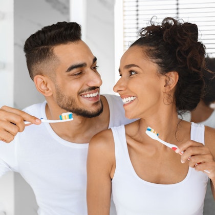 Couple brushing teeth