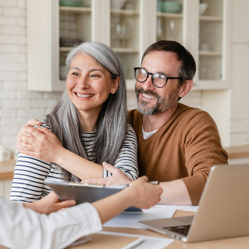 couple smiling while reviewing estate planning