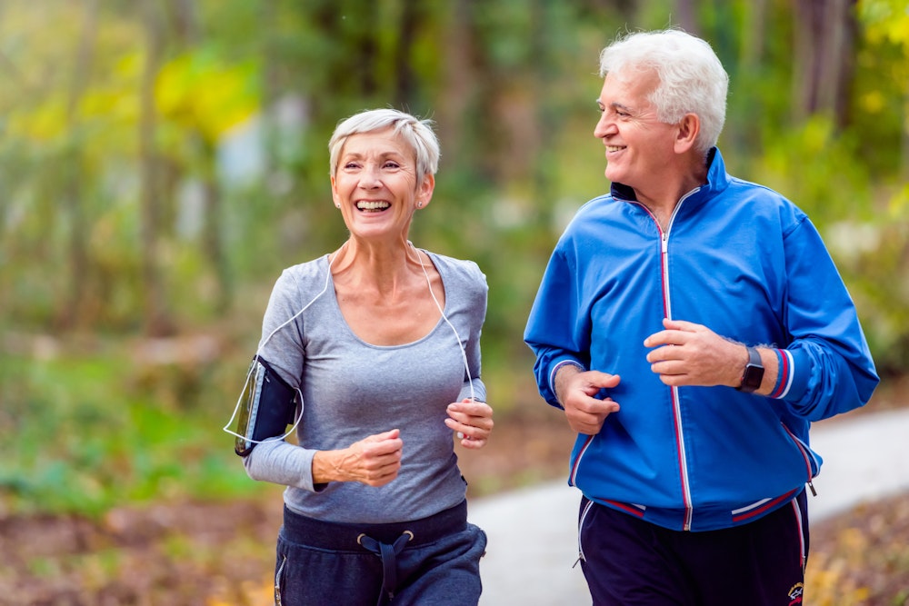 Woman running with man after restorative dental care
